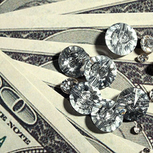 photograph of diamonds on dollar bills